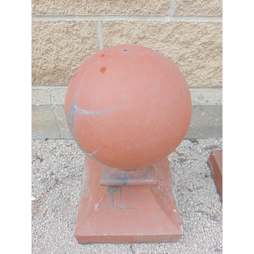 444 - A PAIR OF RED TERRACOTTA CAPPINGS each of cylindrical form raised on a square spreading base 54cm (h... 