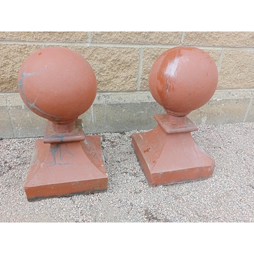 444 - A PAIR OF RED TERRACOTTA CAPPINGS each of cylindrical form raised on a square spreading base 54cm (h... 