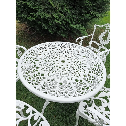 445 - A FIVE PIECE ALUMINIUM PATIO SUITE comprising four elbow chairs each with a pierced foliate back and... 