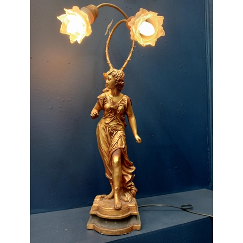 447 - A CONTINENTAL COMPOSITION GILT FIGURAL TABLE LAMP with scroll arms and frosted glass shades 77cm (h)... 