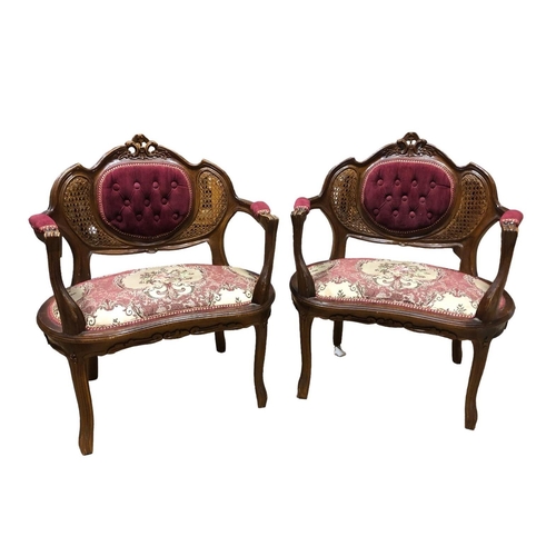 51 - A PAIR OF CONTINENTAL STAINED WOOD AND UPHOLSTERED ARMCHAIRS each with a carved top rail with button... 