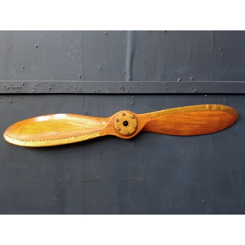 510 - A STAINED WOOD AND BRASS PROPELLER 150cm (w) x 8cm (d)