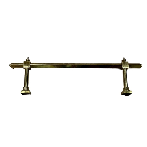 517 - A VINTAGE BRASS RAIL of square form raised on cylindrical supports with urn finials on platform base... 