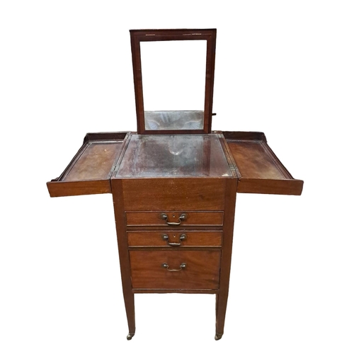 52 - A GEORGIAN MAHOGANY DRESSING STAND of rectangular outline the hinged lids containing a fall and rise... 