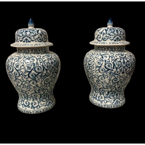 537 - A PAIR OF ORIENTAL BLUE AND WHITE LIDDED JARS each of bulbous form the white ground decorated with s... 