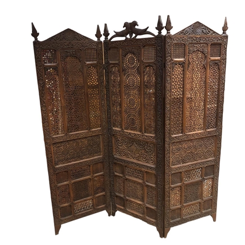 55 - A BURMESE HARDWOOD CARVED THREE FOLD SCREEEN the rectangular arched panels with pierced decoration w... 