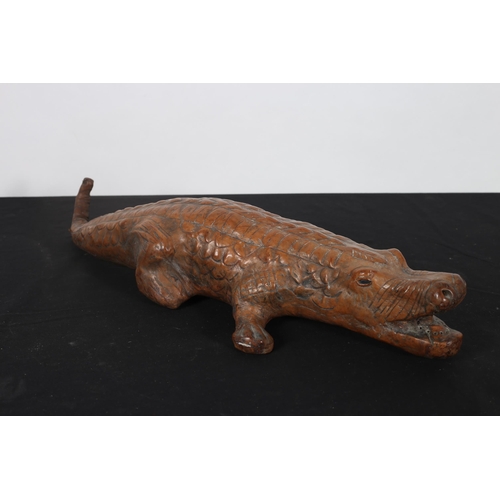 564 - A HIDE FIGURE modelled as a crocodile 57cm (h) x 23cm (w)