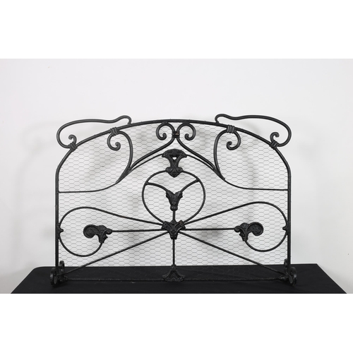 572 - A PAIR OF VINTAGE WROUGHT IRON AND MESH FIRE SCREENS with scroll decoration and mesh panel on scroll... 