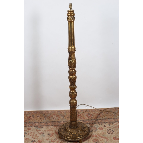 575 - A CONTINENTAL CARVED GILTWOOD FLOOR STANDARD LAMP the fluted and foliate carved column above a circu... 