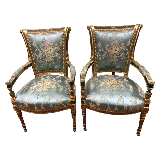 58 - A PAIR OF CONTINENTAL PAINTED PARCEL GILT AND UPHOLSTERED SALOON CHAIRS each with a scroll top rail ... 