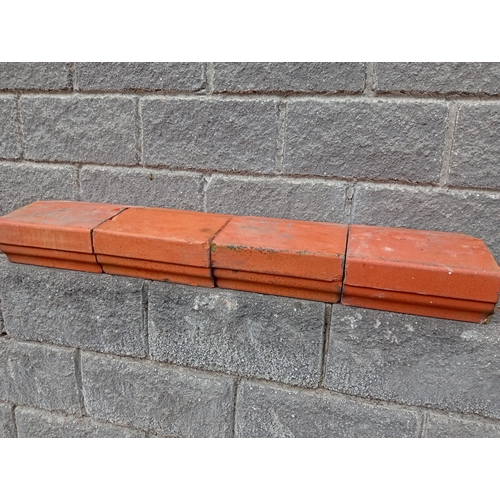 724 - TWENTY FOUR TERRACOTTA CAPPINGS each of rectangular shaped form 14cm (h) x 720cm (w) x 33cm (d)