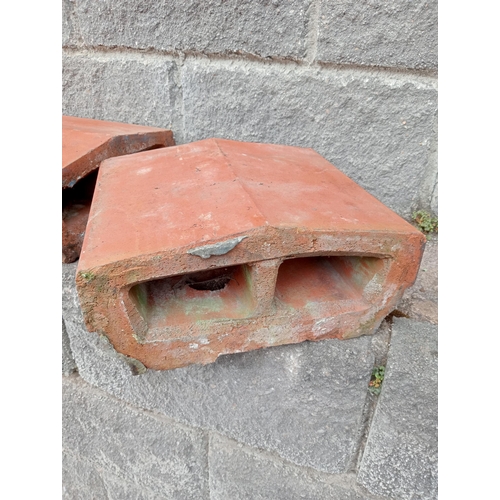 724 - TWENTY FOUR TERRACOTTA CAPPINGS each of rectangular shaped form 14cm (h) x 720cm (w) x 33cm (d)