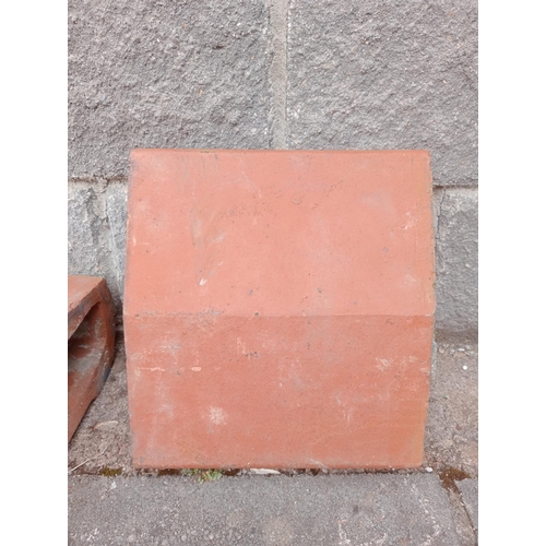 724 - TWENTY FOUR TERRACOTTA CAPPINGS each of rectangular shaped form 14cm (h) x 720cm (w) x 33cm (d)