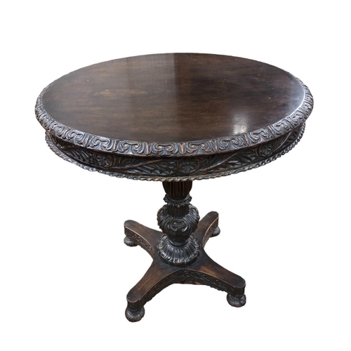 61 - A 19TH CENTURY CARVED ROSEWOOD TABLE the circular top above a carved column on shaped platform base ... 