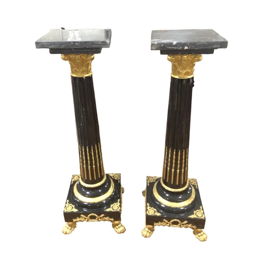 63 - A PAIR OF BLACK LACQUERED GILT BRASS MOUNTED AND MARBLE COLUMNS each with a square black veined marb... 