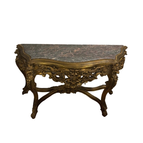 66 - A CONTINENTAL CARVED GILTWOOD AND MARBLE CONSOLE TABLE of serpentine outline surmounted by a veined ... 