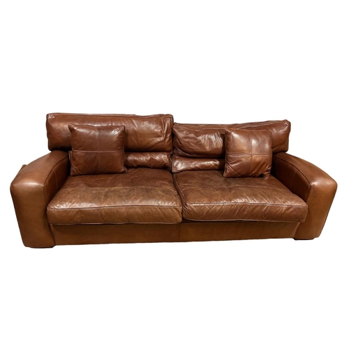 718 - A DESIGNER BROWN HIDE UPHOLSTERED SETTEE the square frame with shaped arms and loose cushions on mou... 