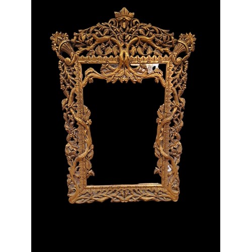 157 - A GILTWOOD CARVED FRAME MIRROR the rectangular plate within a rustic flowerhead and foliate frame wi... 