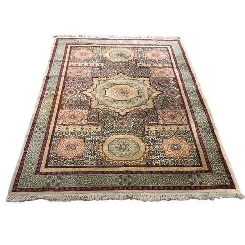 167 - A VINTAGE TURKISH WOOL RUG the beige ground with serrated panels within a conforming border 135cm (w... 