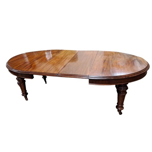 171 - A 19TH CENTURY MAHOGANY TELESCOPIC DINING TABLE of rectangular outline with rounded ends and two loo... 