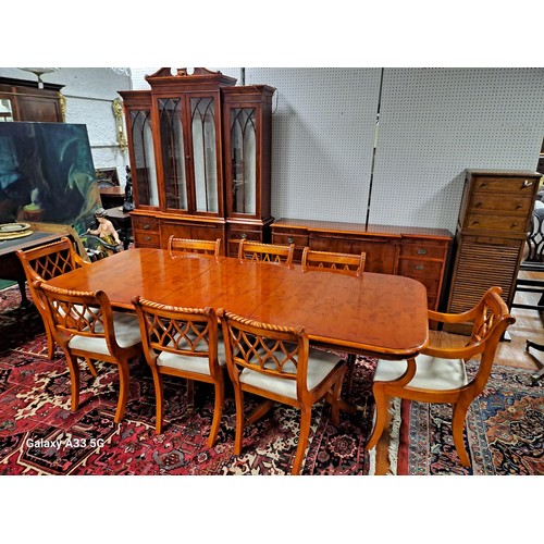 176 - A YEW WOOD ELEVEN PIECE DINING ROOM SUITE comprising EIGHT CHAIRS, including a pair of elbow chairs,... 