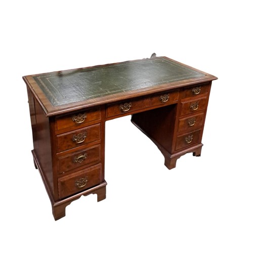 297 - AN EDWARDIAN BURR WALNUT AND MAHOGANY PEDESTAL DESK of rectangular outline the shaped top with toole... 