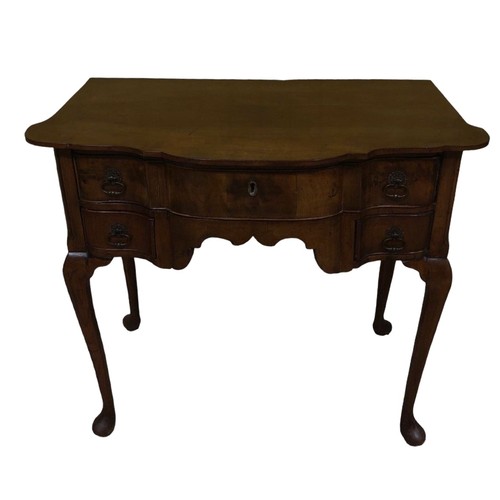 232 - A 19TH CENTURY QUEEN ANNE DESIGN SIDE TABLE of serpentine outline the shaped top above one long and ... 