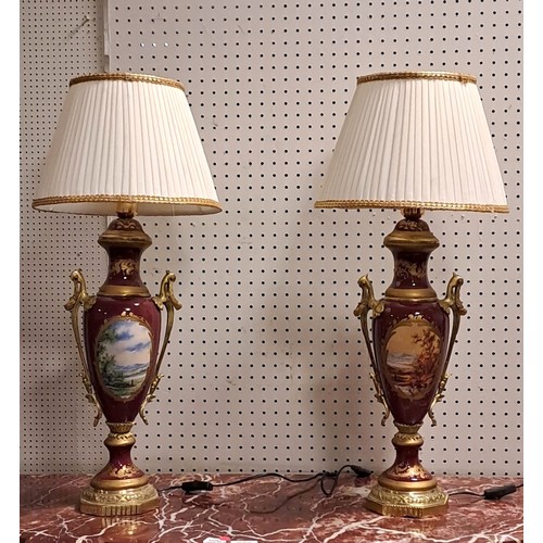 288 - A PAIR OF CONTINENTAL PORCELAIN AND GILT BRASS MOUNTED TABLE LAMPS each of urn form the puce and gil... 