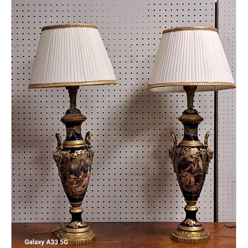 289 - A PAIR OF CONTINENTAL PORCELAIN AND GILT BRASS MOUNTED TABLE LAMPS each of urn form the blue and gil... 