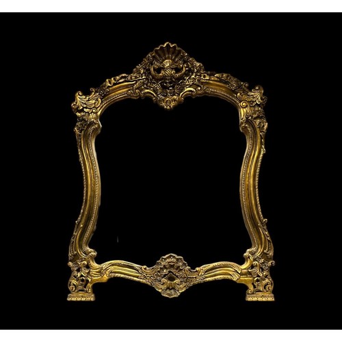 404 - A CONTINENTAL GILT FRAME MIRROR the shaped plate within a gadrooned flowerhead and foliate frame wit... 