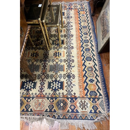 167 - A VINTAGE TURKISH WOOL RUG the beige ground with serrated panels within a conforming border 135cm (w... 