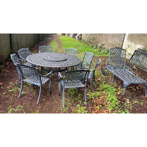 721 - A TEN PIECE CAST ALUMINIUM PATIO SUITE comprising eight elbow chairs each with a latticework and C-s... 