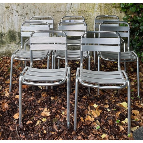 722 - A SET OF EIGHT CHROME PATIO CHAIRS each with a shaped top rail with horizontal splat and seats on tu... 