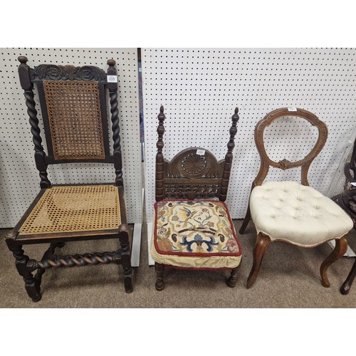 255 - A MOORISH CARVED WOOD LOW CHAIR the stylised foliate pierced splat with upholstered seat on turned l... 