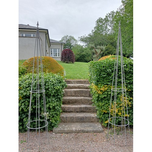 501 - A PAIR OF WROUGHT IRON OBELISKS each of tapering form with fleur de lis finials 290cm (h) x 49cm (d)