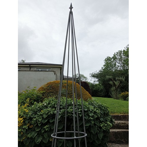 501 - A PAIR OF WROUGHT IRON OBELISKS each of tapering form with fleur de lis finials 290cm (h) x 49cm (d)