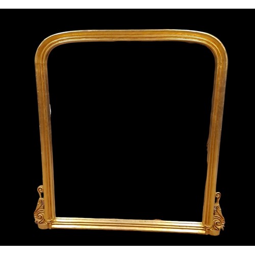 115 - A VICTORIAN STYLE GILTWOOD OVERMANTEL MIRROR the rectangular arched plate within a moulded frame wit... 