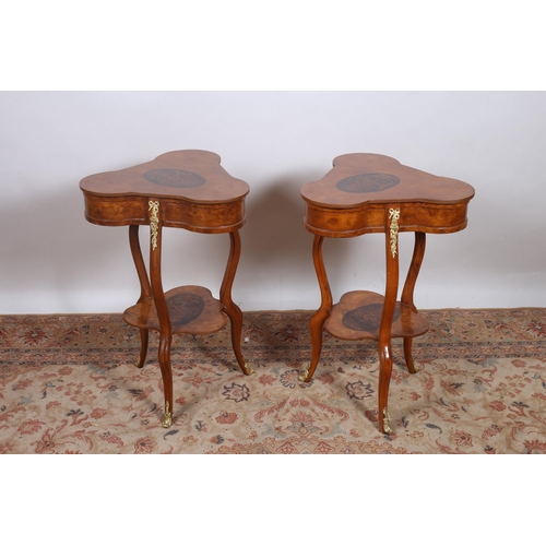 276 - A PAIR OF CONTINENTAL WALNUT MARQUETRY AND GILT BRASS MOUNTED LAMP TABLES each with a shaped top on ... 