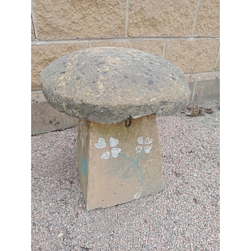 630 - A COMPOSITION SANDSTONE SADDLE STONE the cylindrical top above a spreading column 50cm (h) x 45cm (d... 