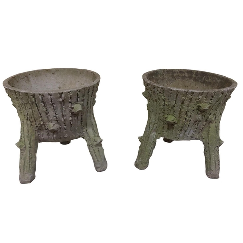 643 - A PAIR OF COMPOSITION STONE RUSTIC PLANTERS each of circular outline on splayed legs 49cm (h) x 45cm... 