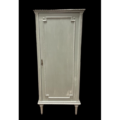 113 - A CONTINENTAL GREY PAINTED SINGLE DOOR CUPBOARD the blind panel door containing four shelves on flut... 