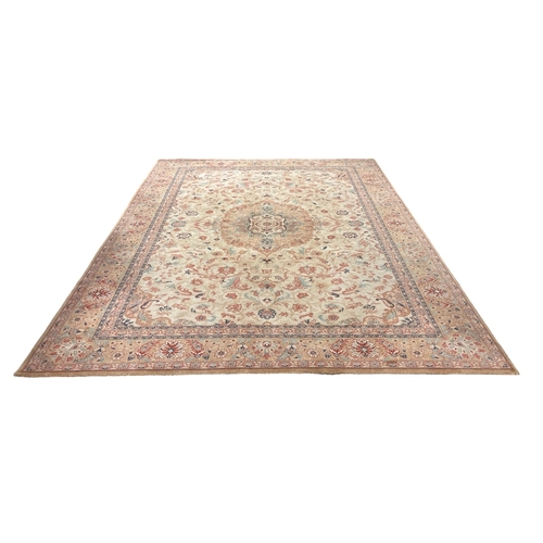 149 - A WOOL RUG the light brown and beige ground with central panel filled with stylised flowerheads and ... 