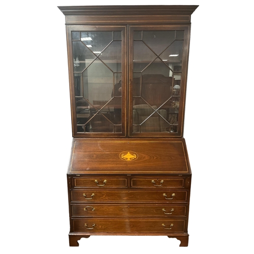 153 - A GEORGIAN STYLE MAHOGANY AND SATINWOOD INLAID TWO DOOR BOOKCASE with astragal glazed doors containi... 