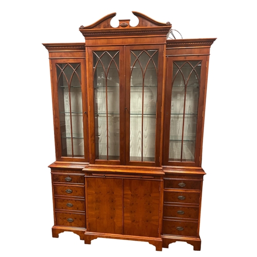 158 - A YEW WOOD BOOKCASE of breakfront outline 220cm (h) x 154cm (w) x 42cm (d)