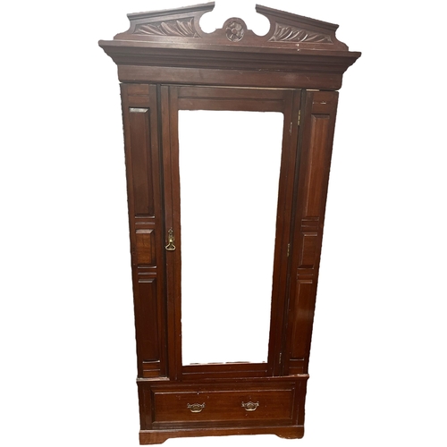 167 - AN EDWARDIAN MAHOGANY SINGLE DOOR WARDROBE with bevelled glass mirror containing two hanging rails t... 