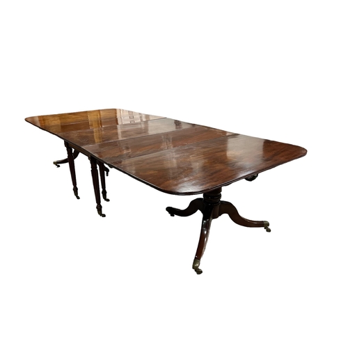 174 - A REGENCY MAHOGANY ECONOMY DINING TABLE with drop leaf central section and two loose leaves on twin ... 