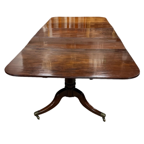 174 - A REGENCY MAHOGANY ECONOMY DINING TABLE with drop leaf central section and two loose leaves on twin ... 