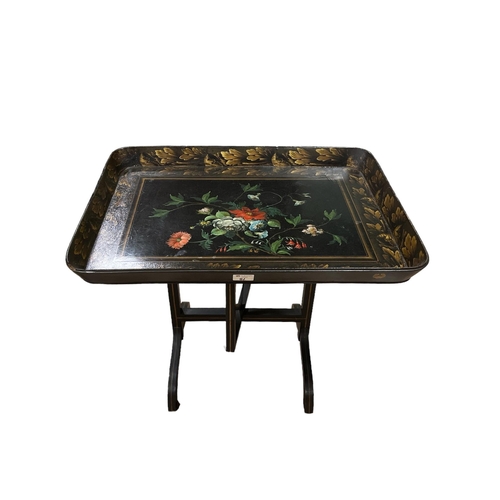 195 - A BLACK LACQUERED AND PAINTED FOLDING COFFEE TABLE on standard end supports with splayed legs 55cm (... 