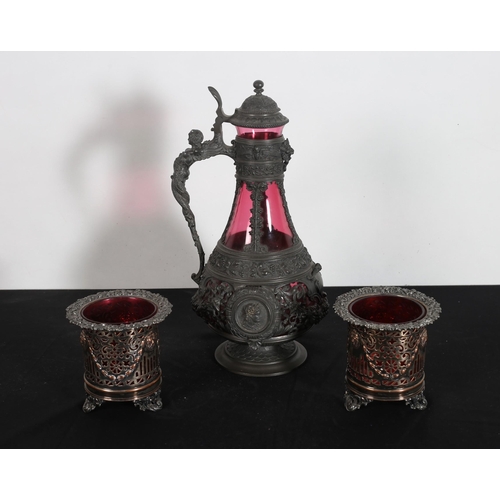 239 - A 19TH CENTURY GERMAN PEWTER CLARET JUG with ruby glass liner 38cm (h), a pair of plated on copper c... 