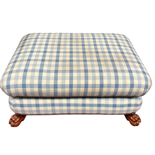 24 - A CHERRYWOOD AND UPHOLSTERED FOOTSTOOL of rectangular outline on carved claw feet 35cm (h) x 83cm (w... 